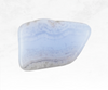A captivating image of a blue lace agate crystal chunk, displaying delicate and intricate patterns in pale blue and white. The crystal's banded appearance resembles soft, flowing lace, imparting a sense of calmness and soothing energy.