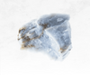 A serene image of an angelite crystal chunk, featuring a soft, powdery blue color. The crystal's surface appears smooth and gentle, emanating a tranquil energy reminiscent of angelic realms.