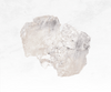 An image showcasing a clear quartz crystal chunk, displaying a transparent or slightly milky appearance. The crystal's pure and radiant nature symbolizes clarity, amplification, and spiritual connection.