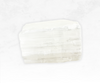 A stunning image of a satin spar selenite crystal chunk, exhibiting a translucent white color with a satin-like sheen. The crystal's fibrous texture and smooth surface create an ethereal glow, evoking a sense of purity and spiritual illumination.