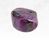 An image of a sugilite crystal chunk, displaying an exquisite combination of purples ranging from deep violet to lilac. The crystal's vibrant colors and polished surface reflect its spiritual and healing properties, promoting inner peace and protection.